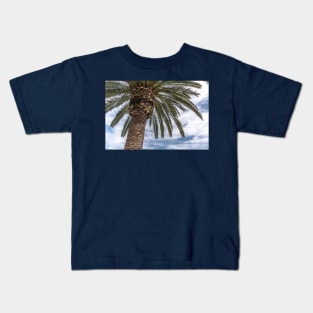 Palm tree against blue cloudy sky Kids T-Shirt